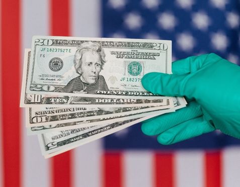 A doctor holding dollar bills